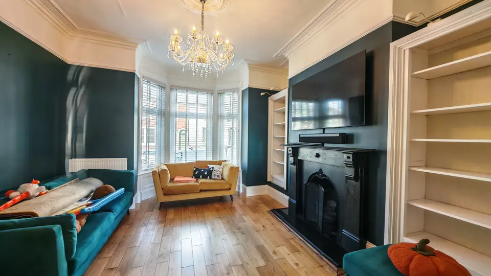 Teal living room towards the bay window