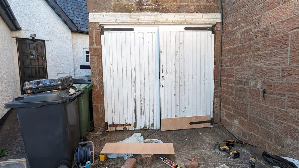 Before: timber garage doors, wider view