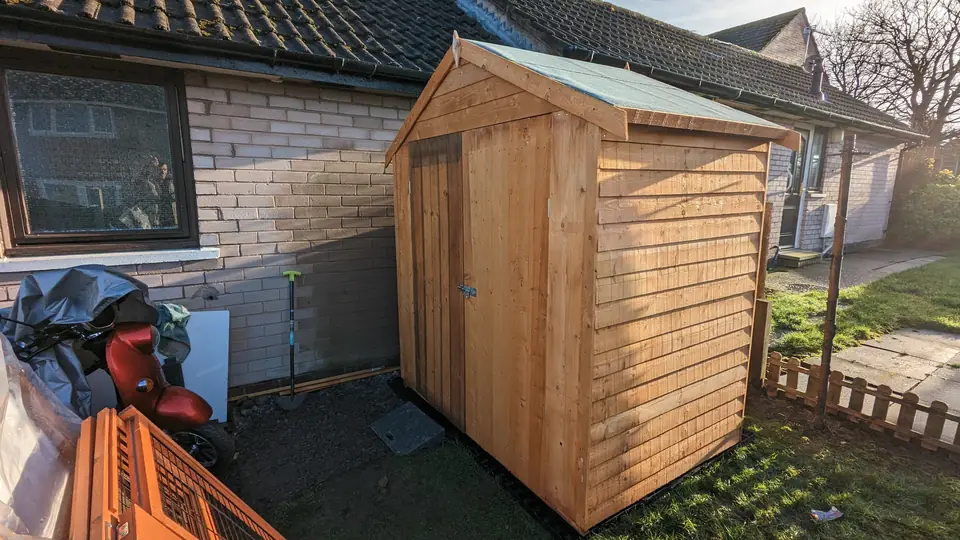 New timber shed installed in a garden