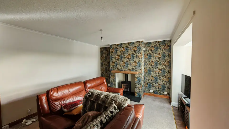 Living room with a tropical wallpaper feature chimney breast