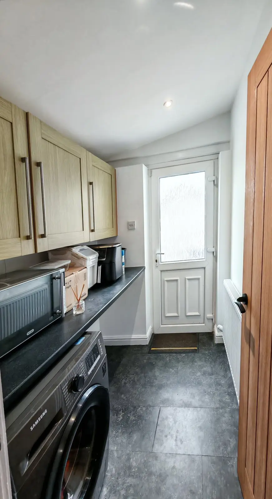After: the same utility room with white ceiling and walls