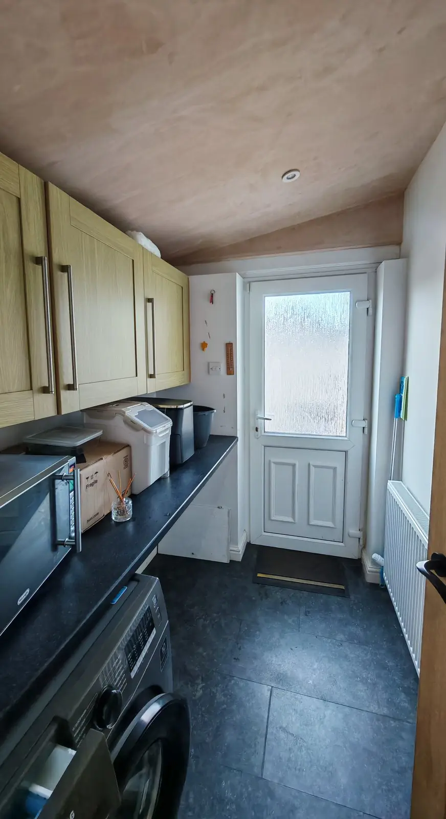 Before: utility room with a bare new plaster ceiling