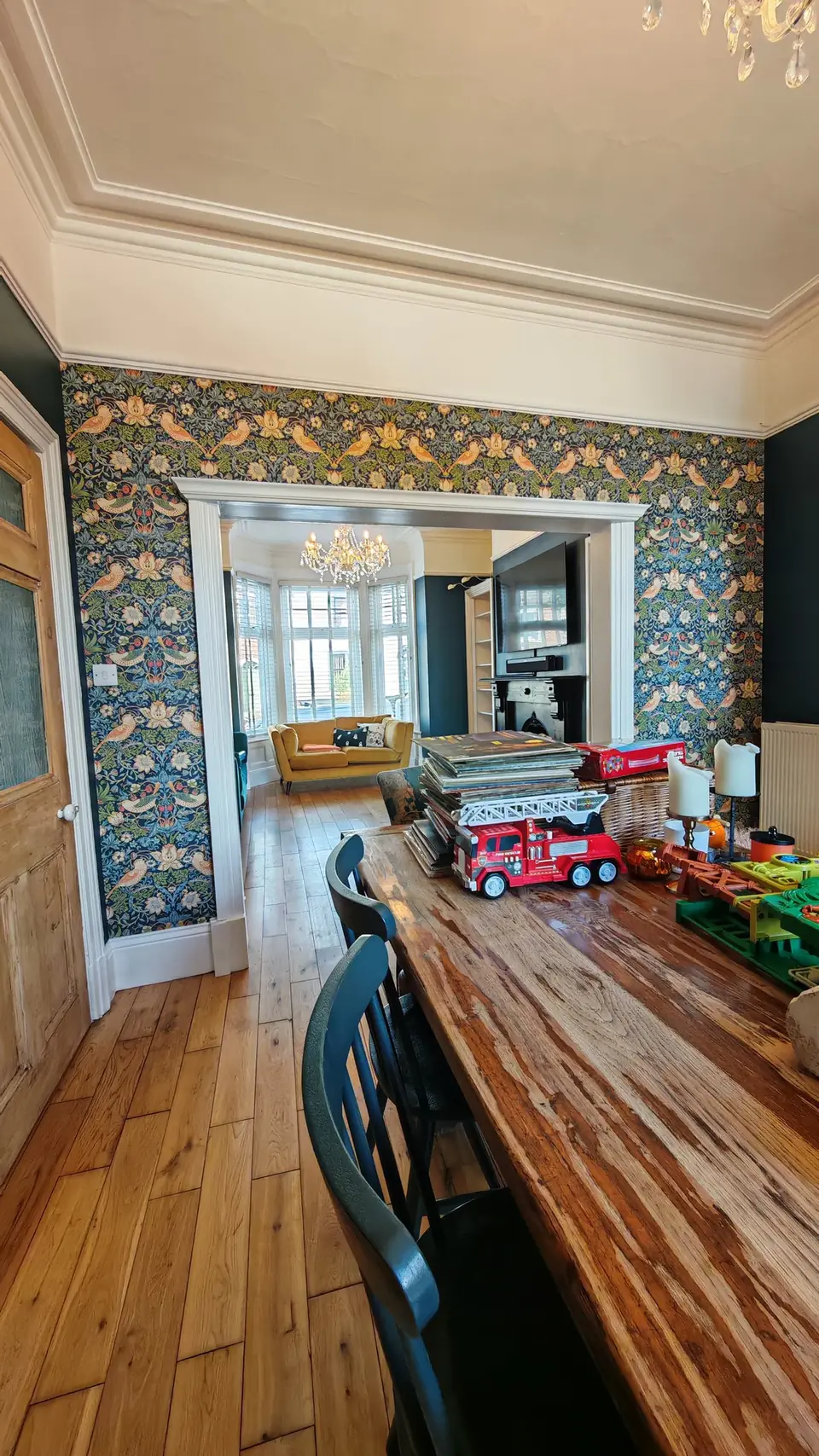 William Morris-style bird and strawberry print wallpaper around the archway