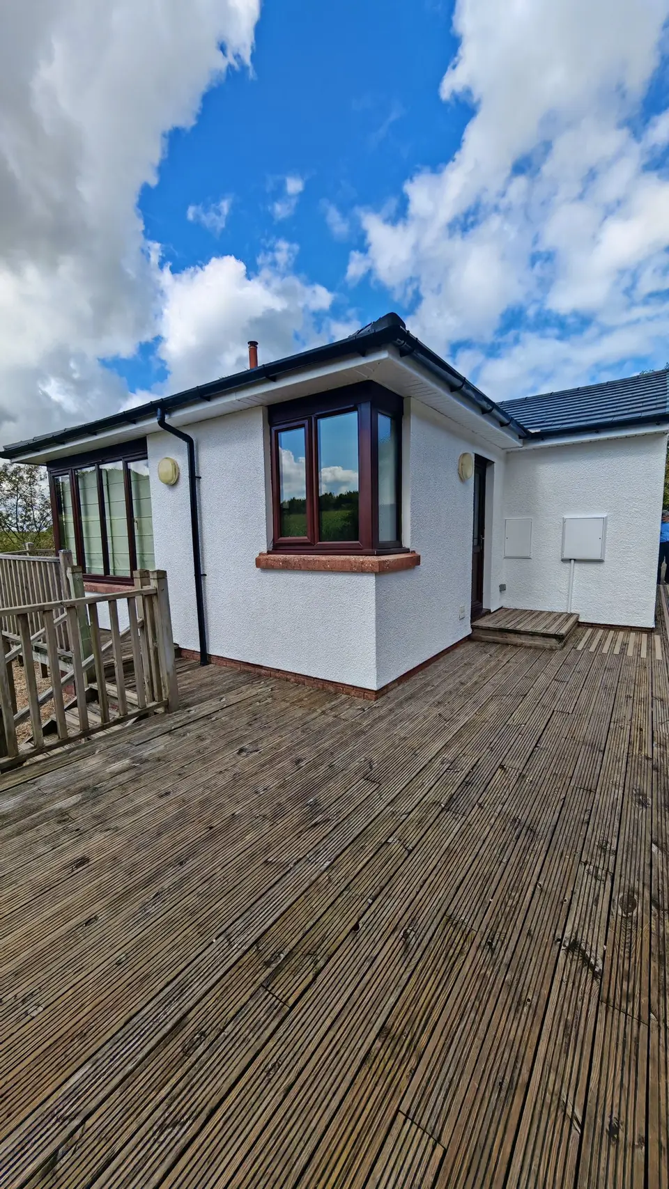 After: render by the decking painted white