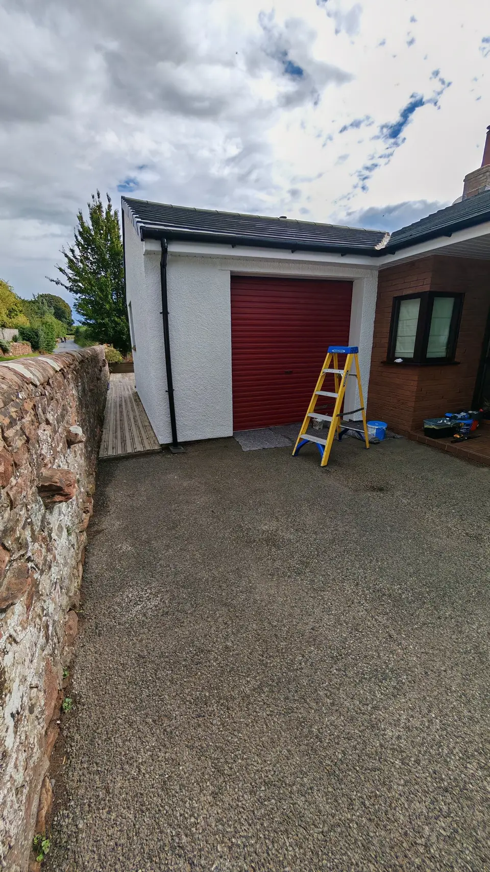 During: garage wall mid-repaint