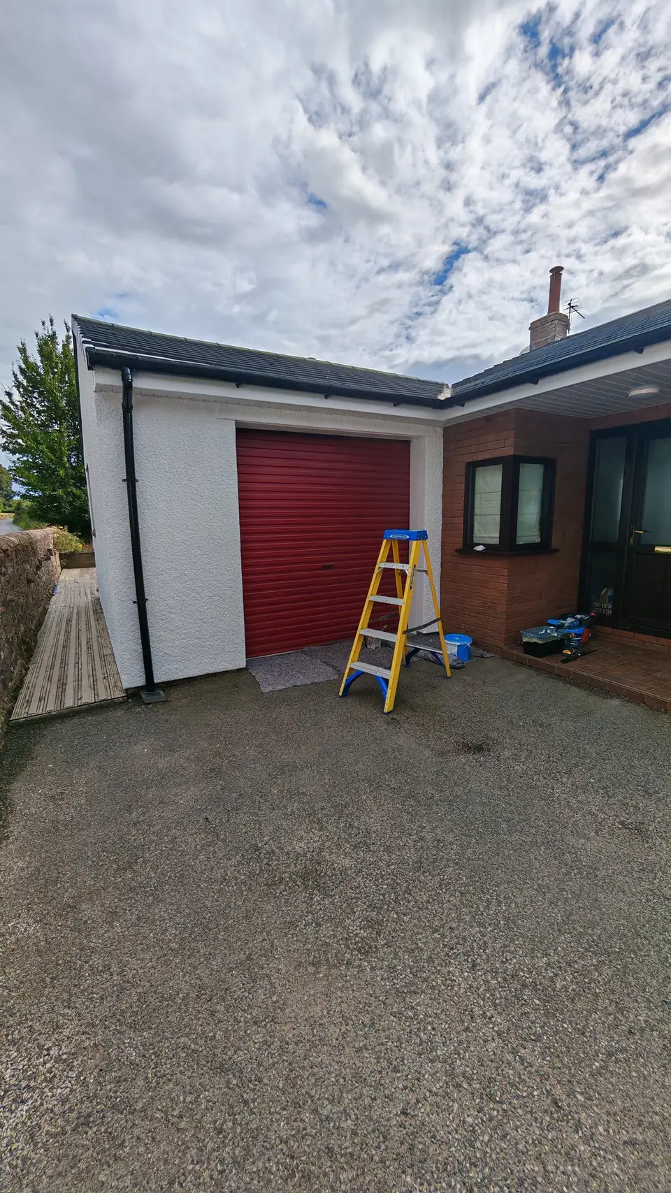 During: ladder up at the garage, walls being painted white