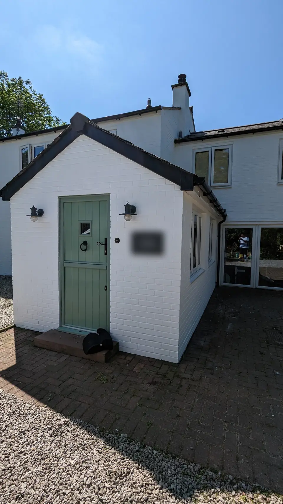Outbuilding with sage green door