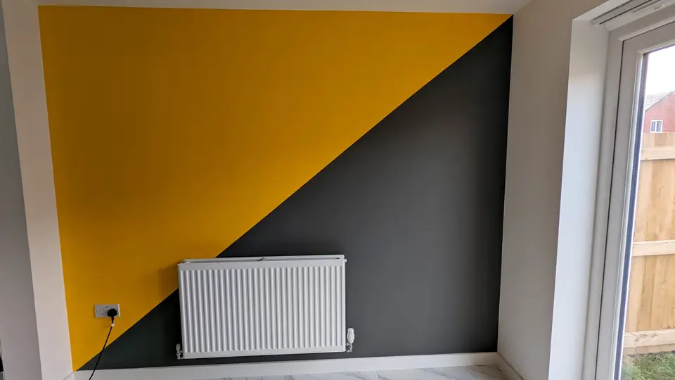 Mustard yellow and charcoal diagonal feature wall